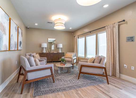 A living room with a grey sofa, a wooden coffee table, and a rug.