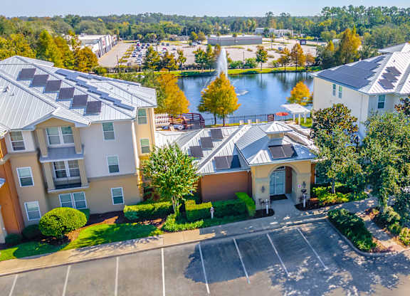 A view of apartment buildings with a lake in the background.