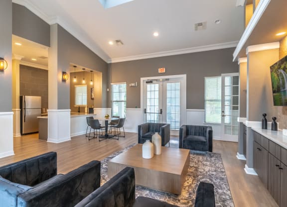 a living room with couches and chairs and a table