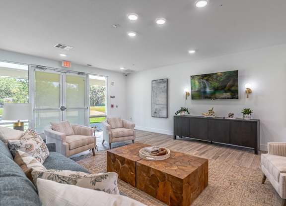 A living room with a couch, chairs, and a coffee table.