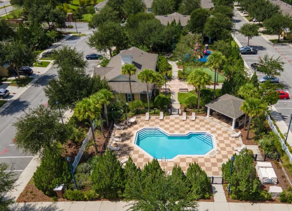 an aerial view of a home with a swimming pool in the front yard