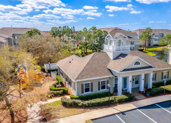an aerial view of a house with a pool and other houses