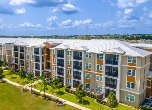 an aerial view of a large apartment complex with a blue sky in the background