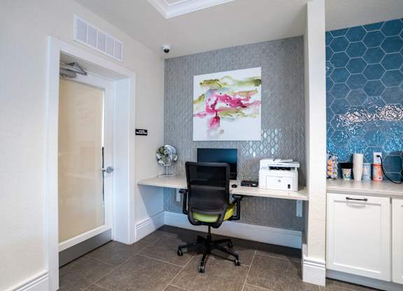A room with a desk and a chair.