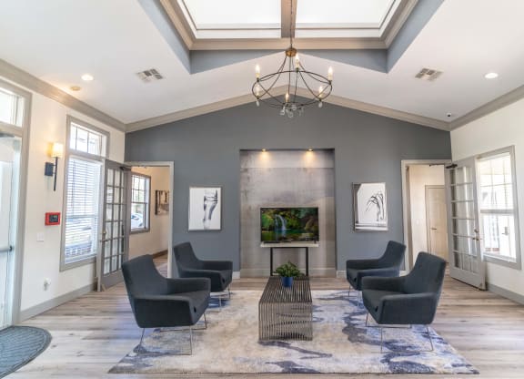 a large living room with chairs and a fireplace
