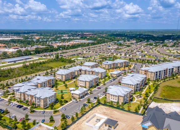 an aerial view of a group of apartment buildings and a parking lot