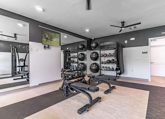A spacious home gym with a variety of exercise equipment.
