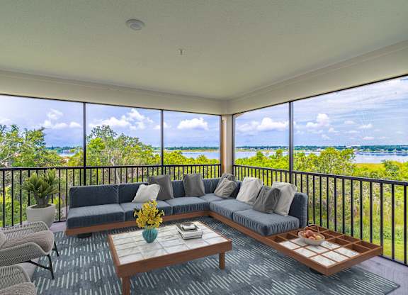 A living room with a view of the lake