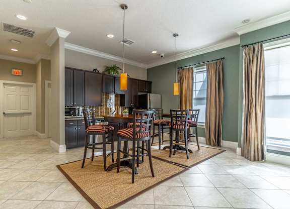 A dining room with a table set for six.