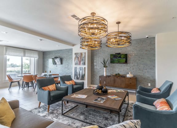 a living room with couches and chairs and a table with a bowl of fruit on it