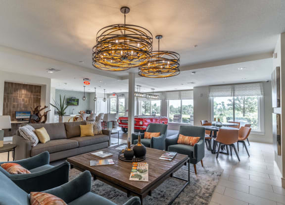 clubhouse with couches and chairs and a table with a vase on it