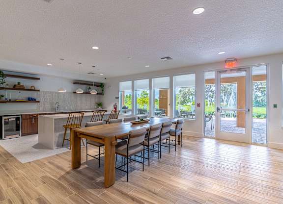 A modern kitchen with a dining table and chairs.
