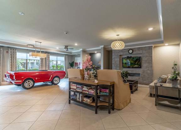 Pool table in a clubhouse room with a television and a couch.