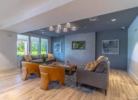 A living room with a grey couch and a yellow table.