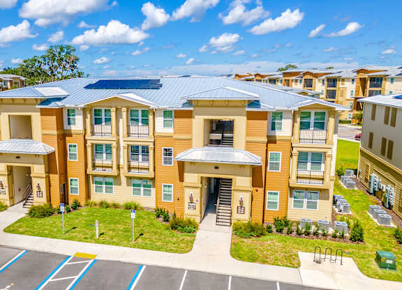 A sunny day at a residential complex with a building in the foreground.