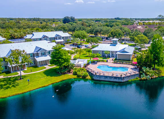 A bird's eye view of a residential area with houses and a swimming pool.