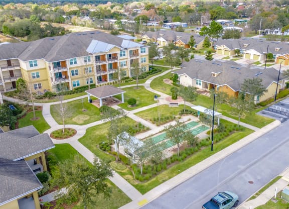 an aerial view of a neighborhood with houses and a tennis court
