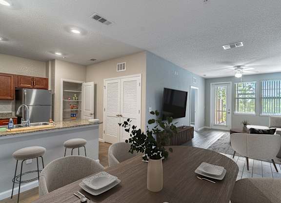 A modern kitchen with a dining table set for two.