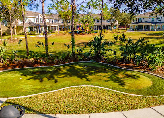 A well-manicured lawn with a white border and a curved walkway in the middle.