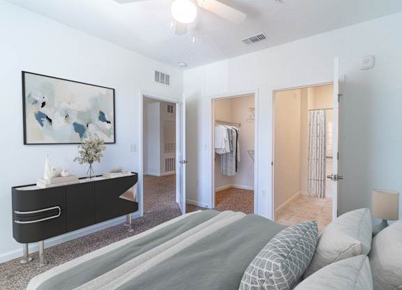 A bedroom with a bed, dresser, and mirror.