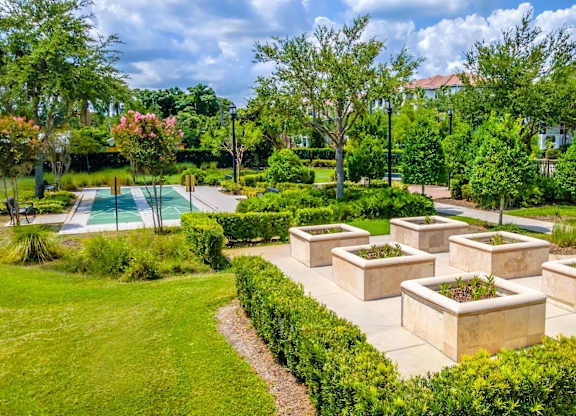 A garden and a building in the background.