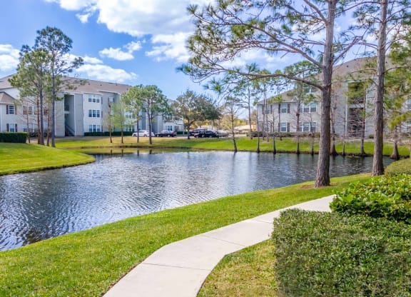 the preserve at ballantyne commons walking path to waterway with apartment buildings