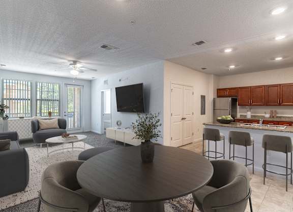 A modern living room with a round table and grey chairs.