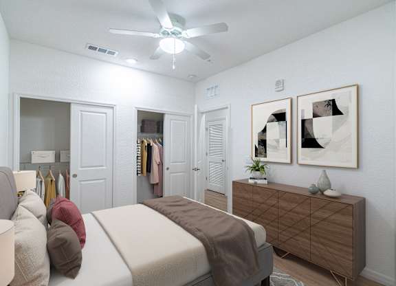 A bedroom with a bed, a dresser, and a ceiling fan.