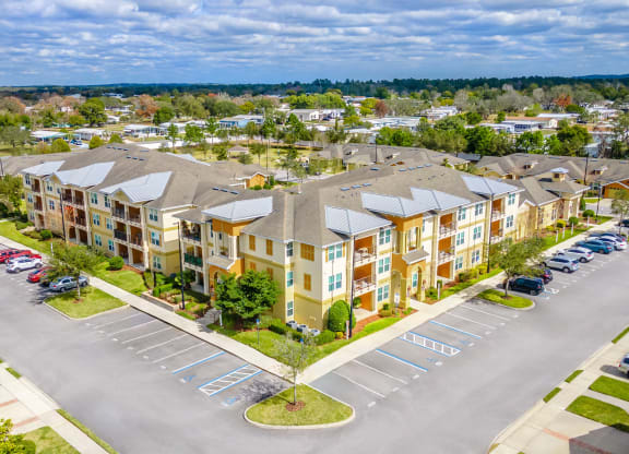 an aerial view of an apartment building in a parking lot