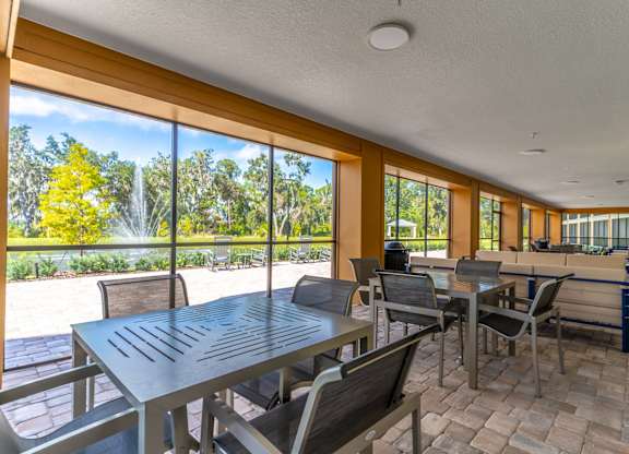 A patio with a table and chairs overlooking a garden.