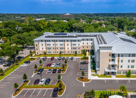 an aerial view of an apartment building and parking lot