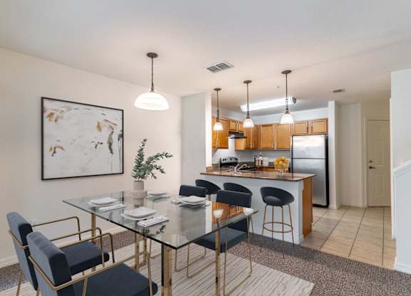 A modern dining area with a glass table and chairs.