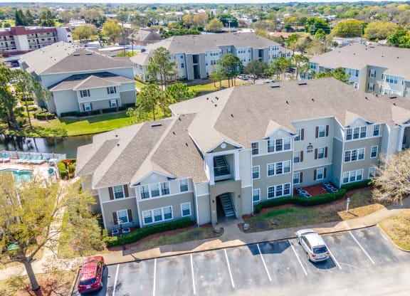 an aerial view of a large building with cars parked in front of it