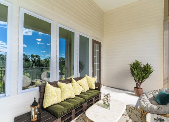 a covered porch with a couch and a table