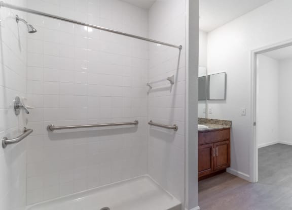 a bathroom with a shower and a sink and a mirror