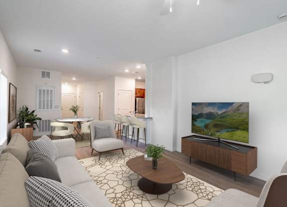 A modern living room with a large TV and comfortable seating.
