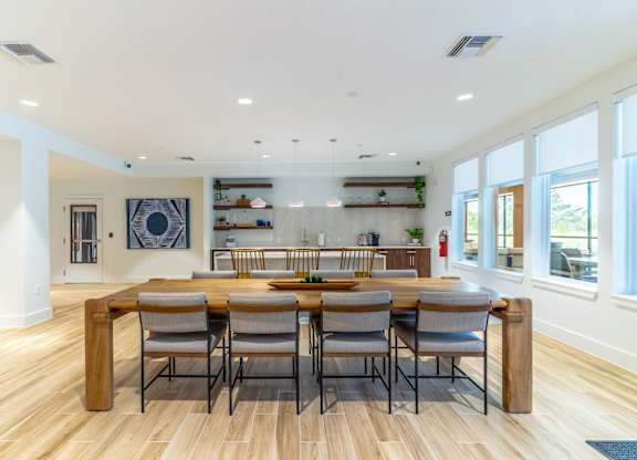 A dining room with a wooden table and chairs.