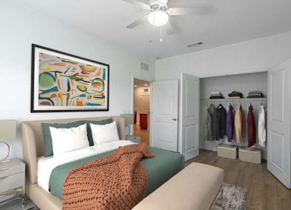 A bedroom with a bed, a couch, and a painting on the wall.