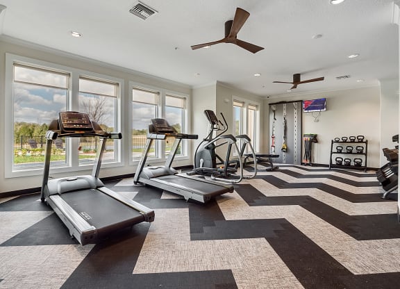 fitness center with equipment and mirror