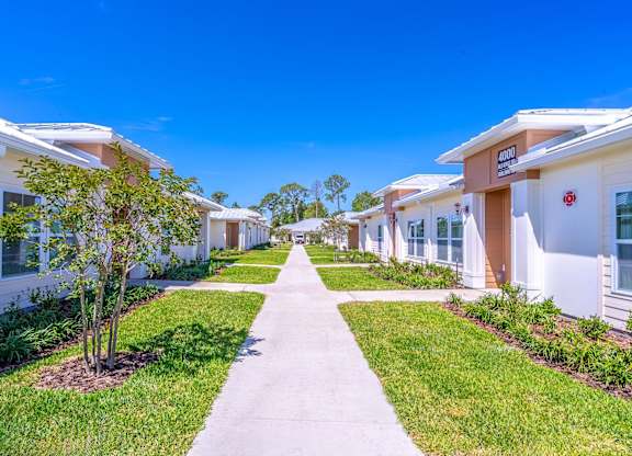 A row of houses with a walkway in between.