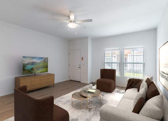 A living room with a brown chair, a white couch, and a painting on the wall.