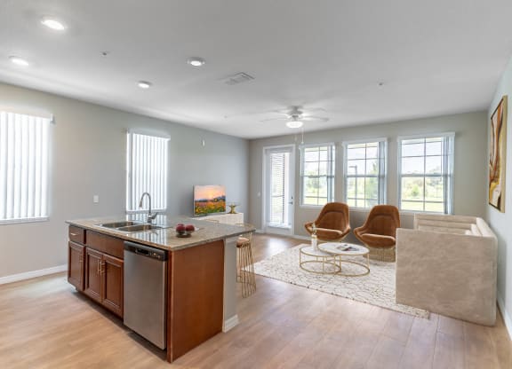 a kitchen and living room with a couch and a counter top