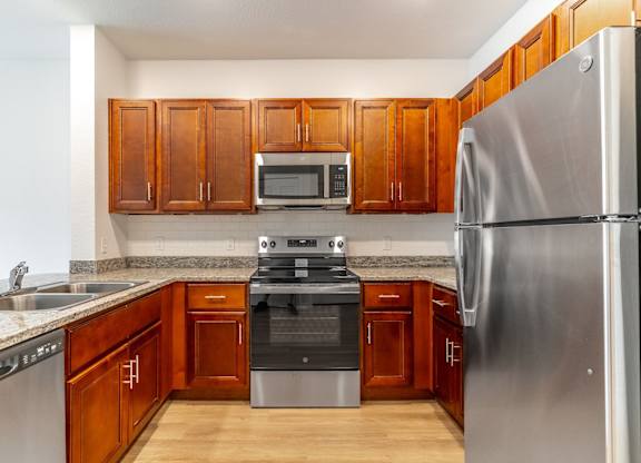 A kitchen with wooden cabinets and stainless steel appliances.