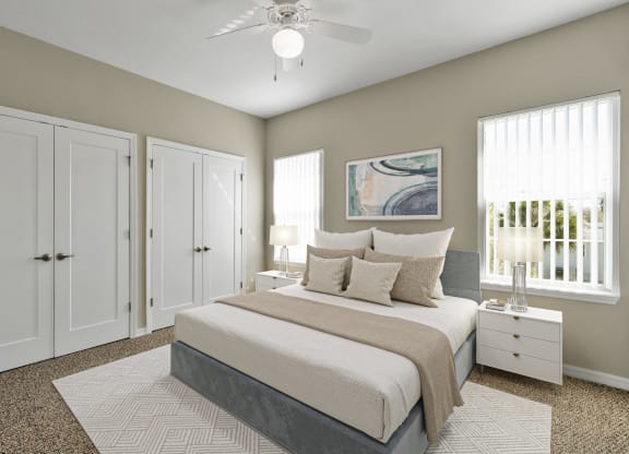 a bedroom with a bed and two windows