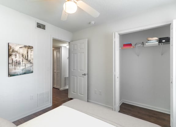 a bedroom with a bed and a ceiling fan