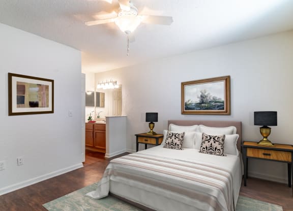 a bedroom with a bed and a ceiling fan