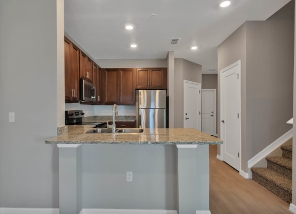 a kitchen with an island and stainless steel appliances