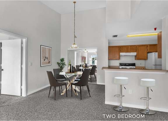 A two bedroom apartment with a kitchen and dining area.