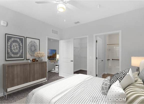 A bedroom with a bed, dresser, and mirror.