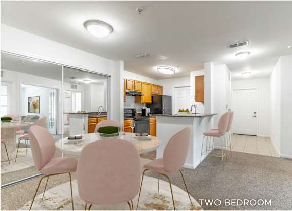 A modern kitchen with a dining table and chairs.